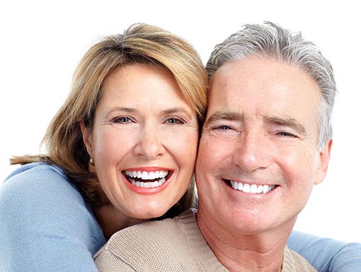 elderly couple smiling outdoors