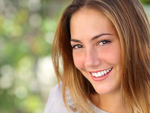 woman smiling showing her healthy gums